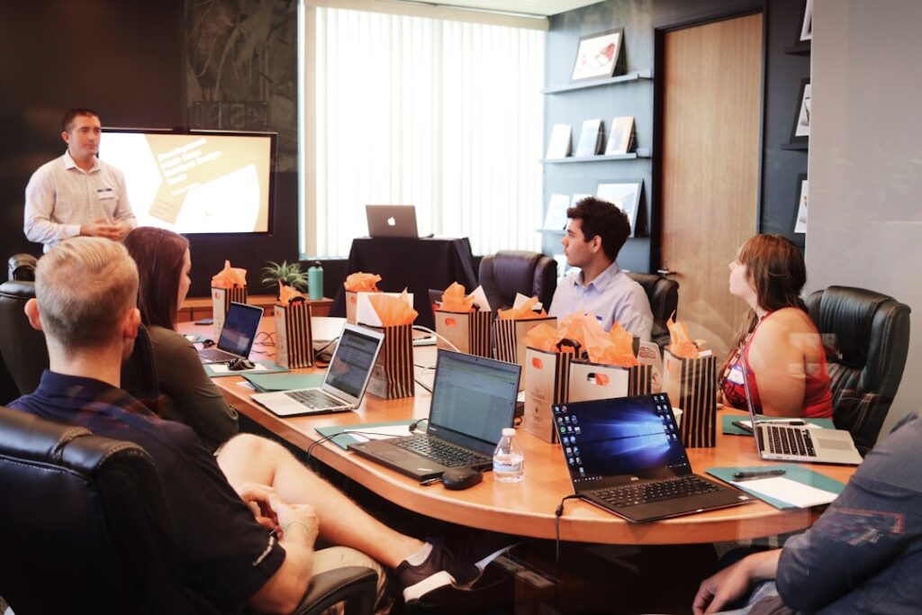 A team in an office discussing a knowledge management system during a meeting